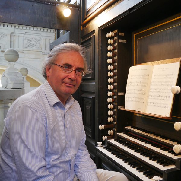 David Ponsford sits at an organ keyboard, facing camera.