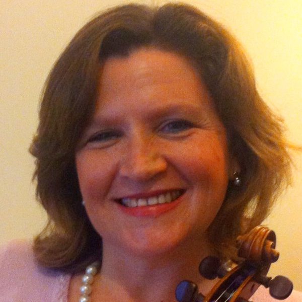Erica Grajner poses for photo, holding a violin.