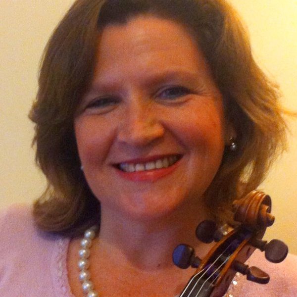 Erica Grajner poses for photo, holding a violin