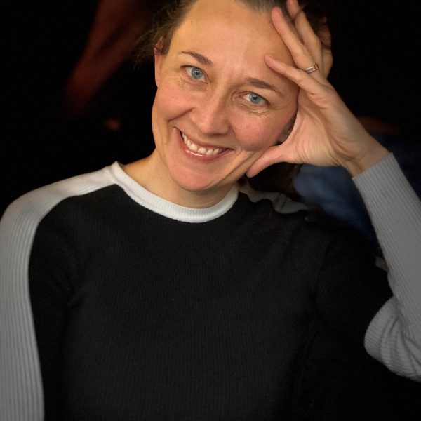 Fiona Harris sits, posing for headshot, smiling