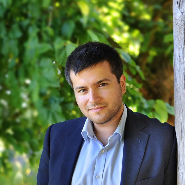 Florian Mitrea stands outside posing for a headshot.