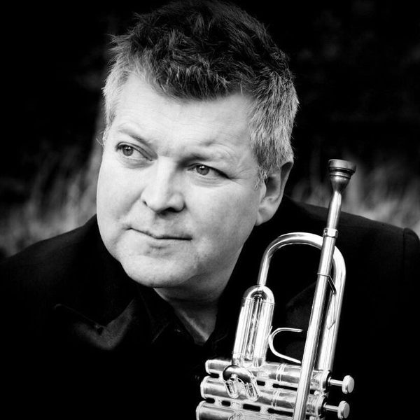 Portrait of Gareth Small holding a trumpet.