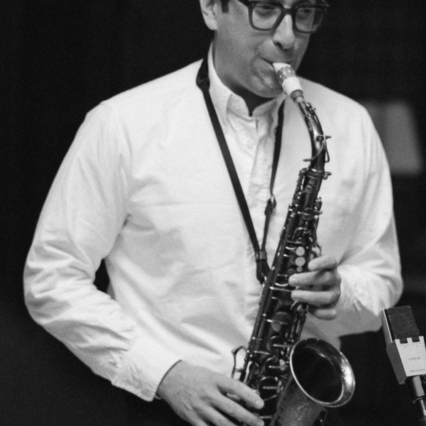 A black and white image of a performing saxophonist