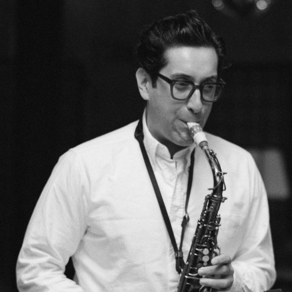 A black and white image of a performing saxophonist.