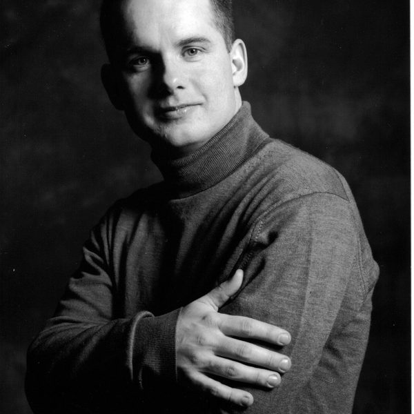 Black and white image of Graham Caskie posing for headshot