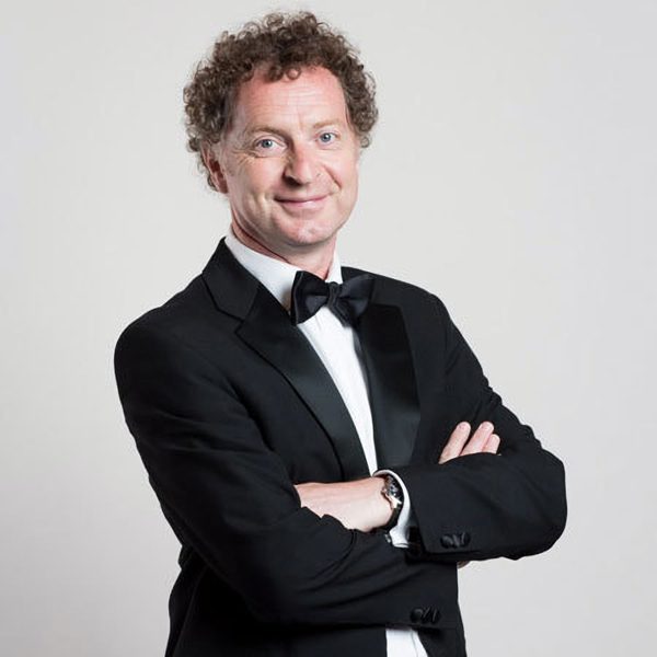 Ian Hardwick smiles, with arms crossed.