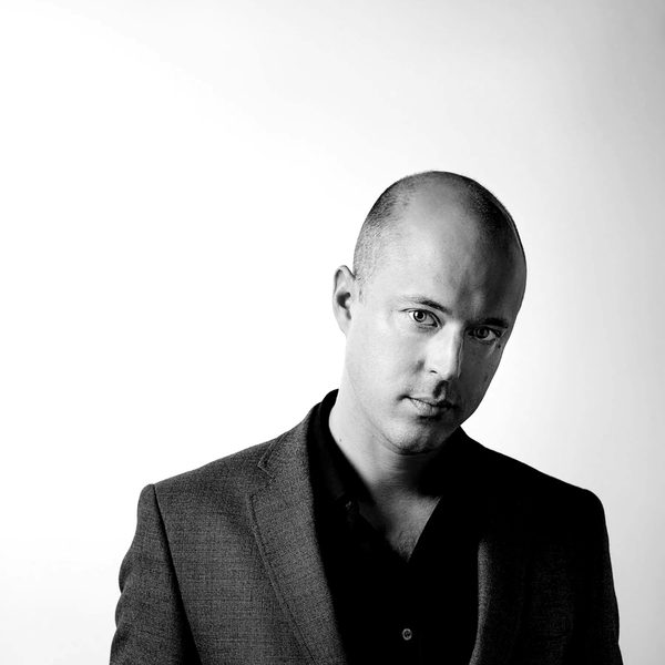 James Spilling dressed in a suit, standing against a white background facing camera.