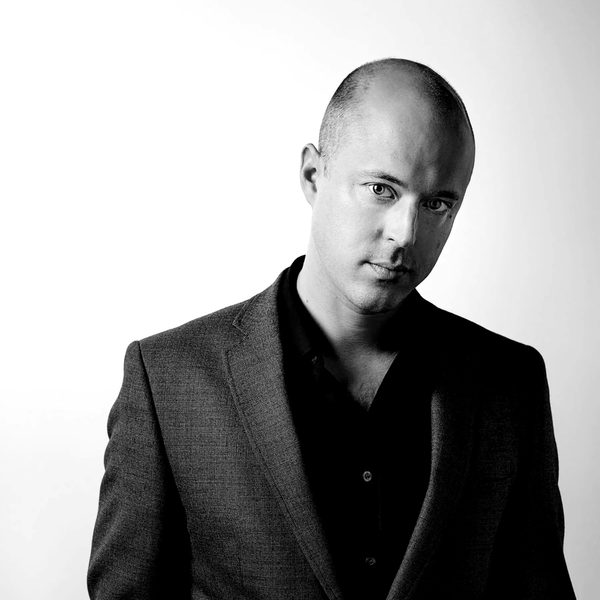 James Spilling dressed in a suit, standing against a white background facing camera