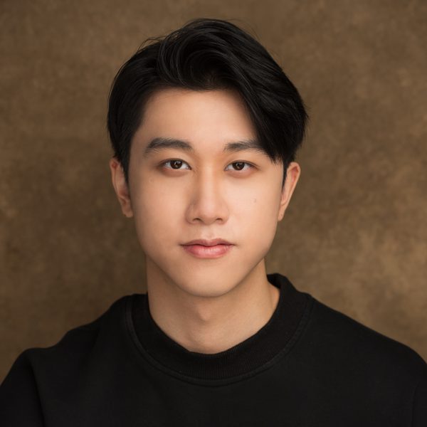 James Wang smiles to camera.