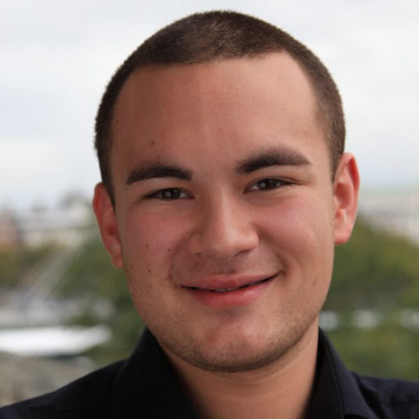 Portrait of Jason Evans smiling to camera.