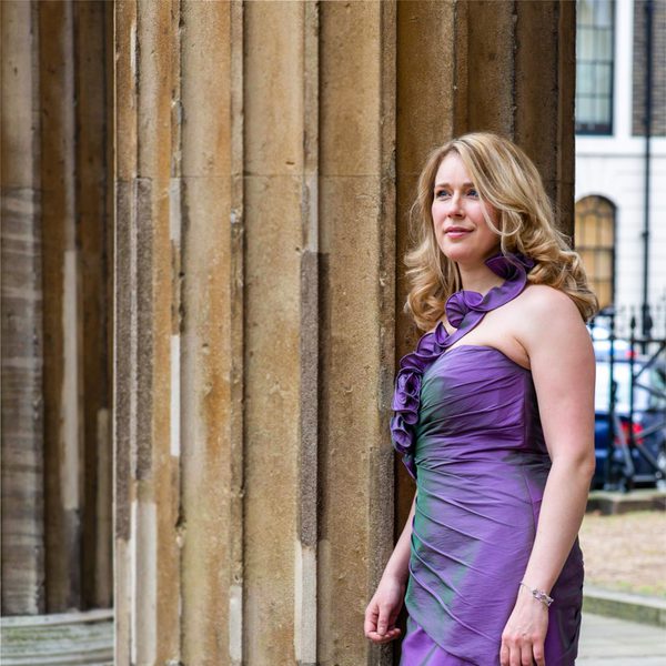 Jocelyn Freeman standing by a building column.