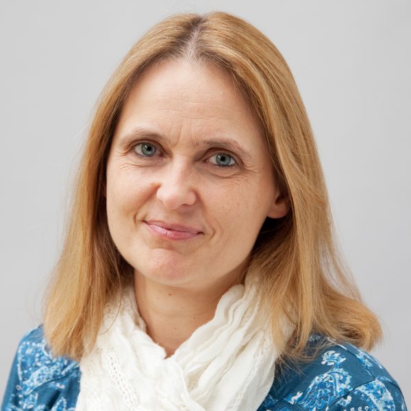 Johanna Mayr smiles to camera wearing a scarf