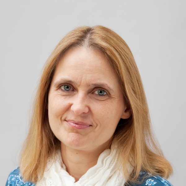 Johanna Mayr smiles to camera wearing a scarf.