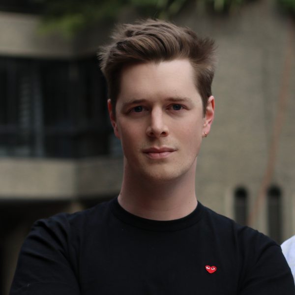 John Lattimore poses with arms folded.