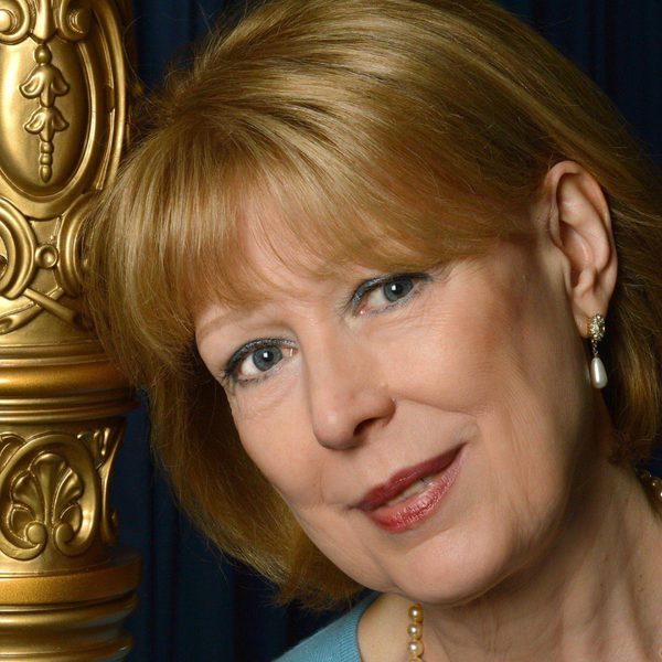 Karen Vaughan with bronze harp.