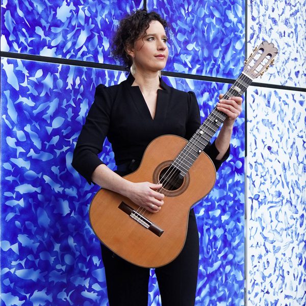 Katalin Koltai holds a guitar.