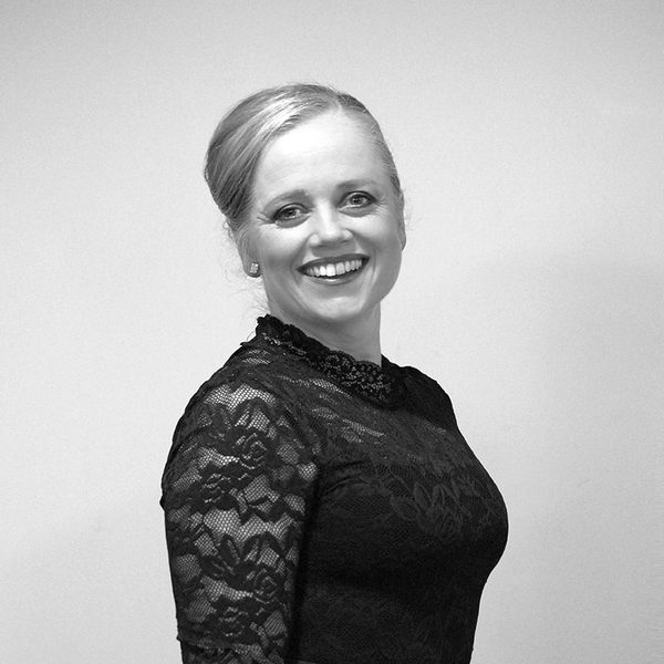 Side portrait of Kate Paterson in concert dress, smiling for camera.