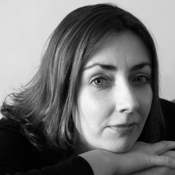 Liz Poole poses for camera, leaning her head on crossed hands