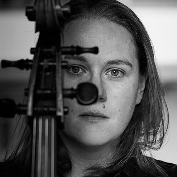 Portrait of Louisa Tuck holding a violin in front of face.