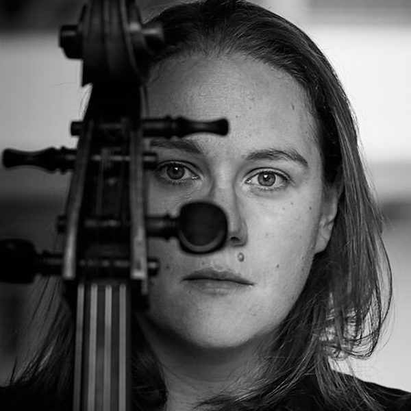 Portrait of Louisa Tuck holding a violin in front of face.