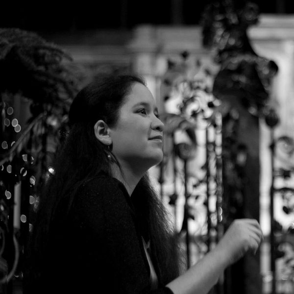 Lynn Arnold mid-performance, sat at a piano.