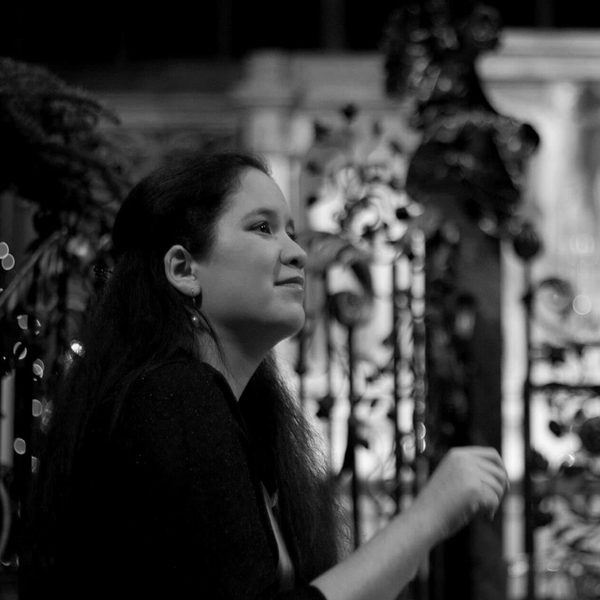 Lynn Arnold mid-performance, sat at a piano.