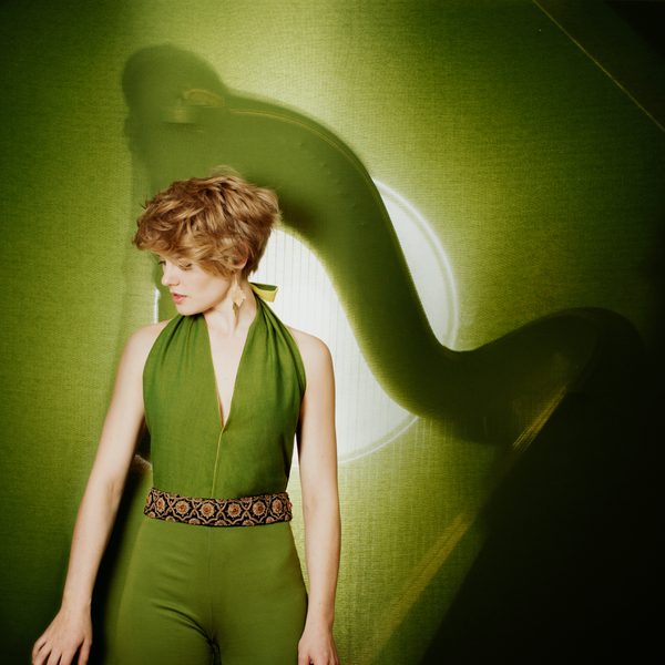 Magdalena Hoffmann stands posing in a green outfit.