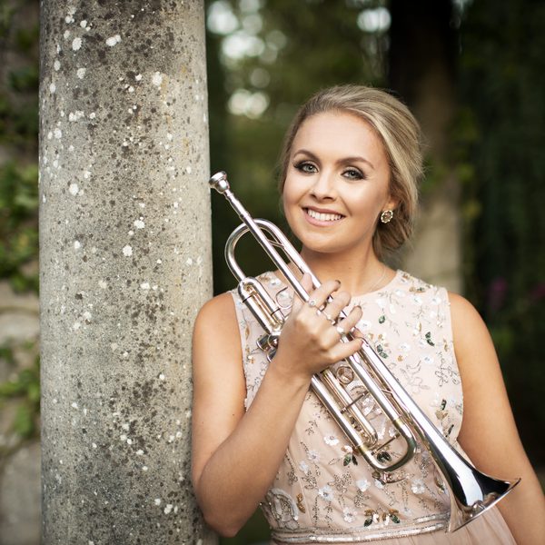 Matilda Lloyd holding a trumpet.