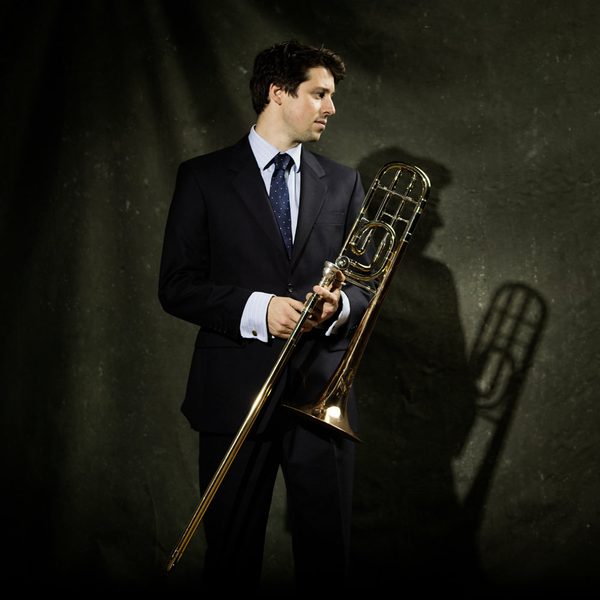 Matthew Knight holds a trombone.