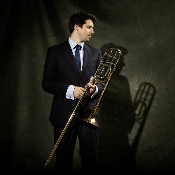 Matthew Knight holds a trombone.