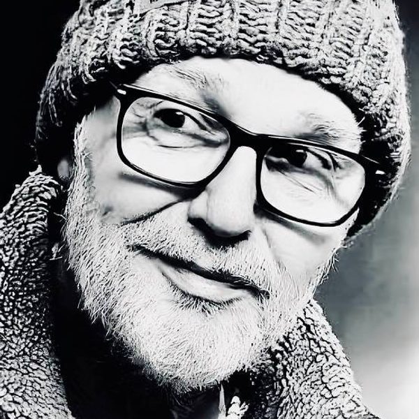 Close up portrait of Mike Walker in black and white, looking to something off camera.
