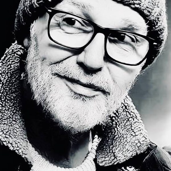 Close up portrait of Mike Walker in black and white, looking to something off camera.