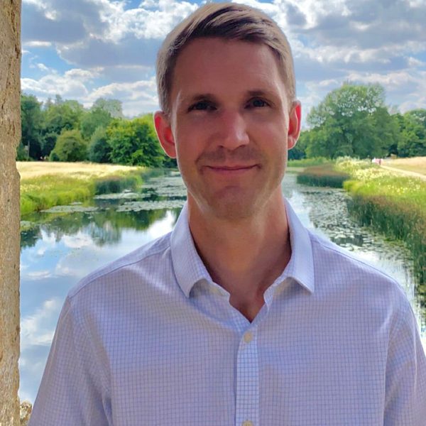 Oliver Philips stands outdoors for a headshot