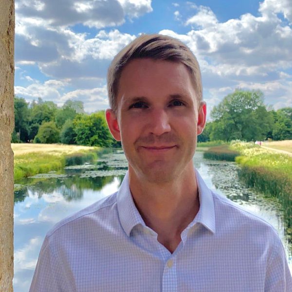 Oliver Philips stands outdoors for a headshot.