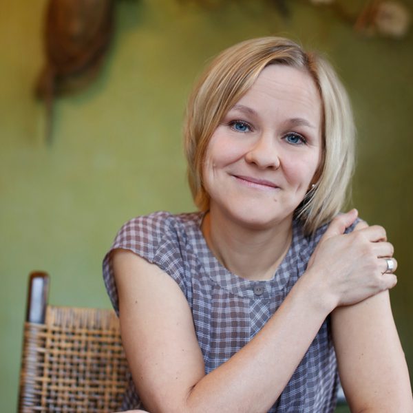 Lotta Wennakoski smiling to camera with hand on shoulder