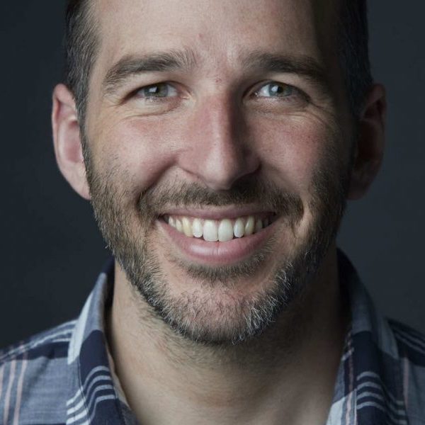 Close up headshot of Patrick King smiling to camera.