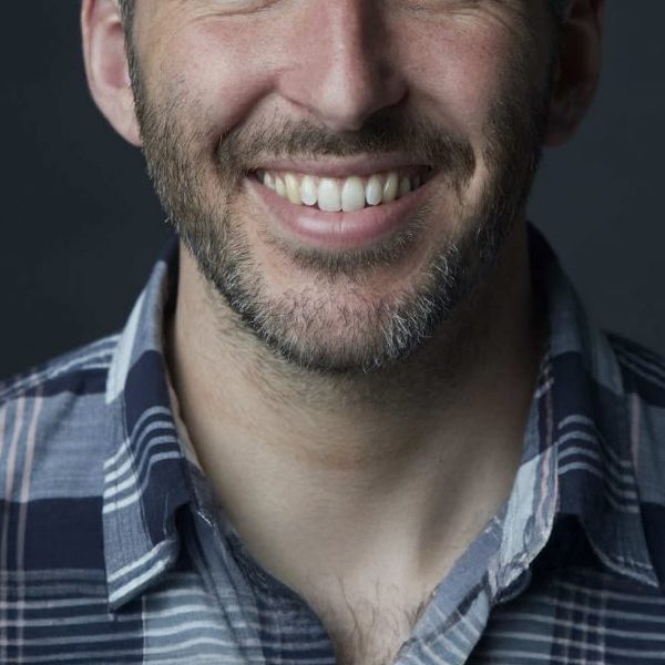 Close up headshot of Patrick King smiling to camera.