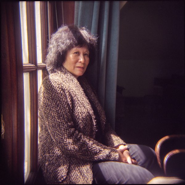 Patsy Toh poses for camera, sat near a sun-lit window.