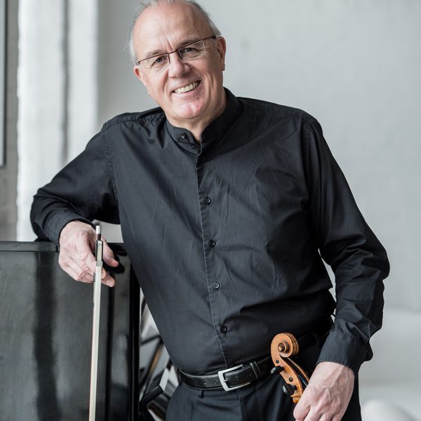 Paul Silverthorne stands for headshot, holding a viola.