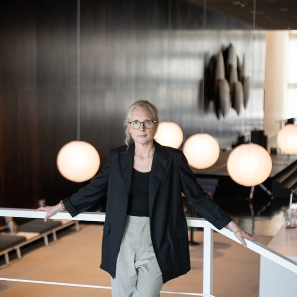 Rebecca Saunders poses for camera in a modern interior.