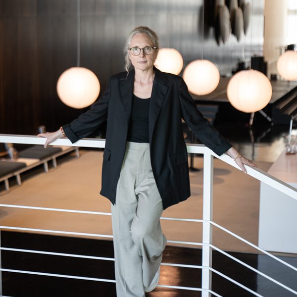 Rebecca Saunders poses for camera in a modern interior.