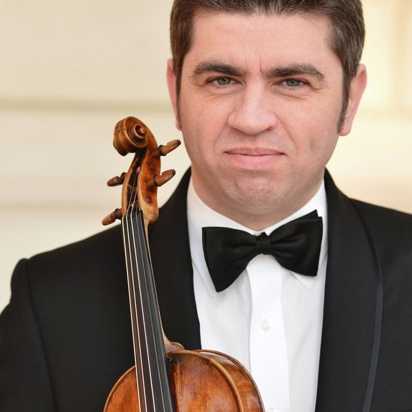 Portrait of Remus Azoiței holding a violin.