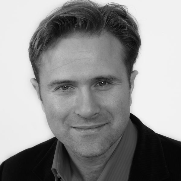 Robert sholl smiles to camera.