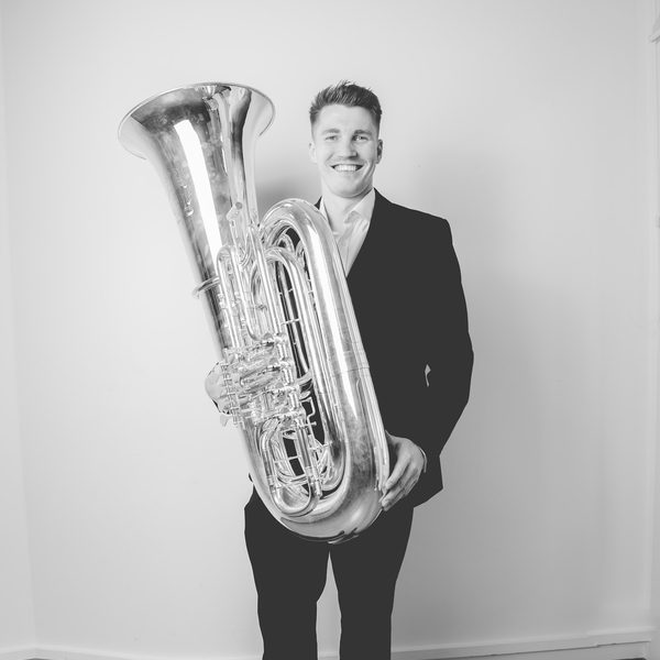 Ross Knight holding a tuba.