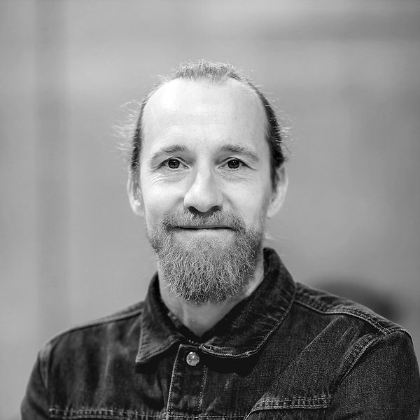 Portrait of Sam Kenyon smiling to camera.