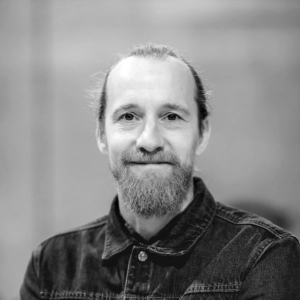 Portrait of Sam Kenyon smiling to camera.