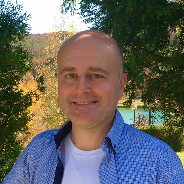 Sarkis Zakarian poses for camera in a rural setting.