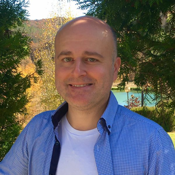 Sarkis Zakarian poses for camera in a rural setting.