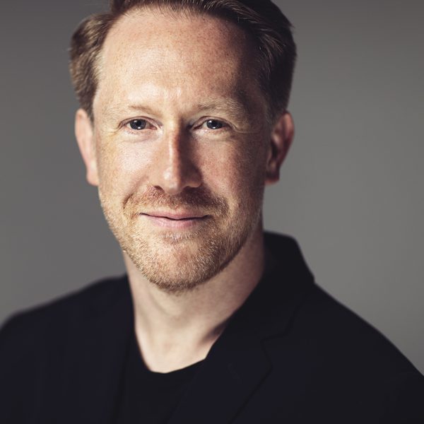 Simon Crawford-Phillips smiling to camera.