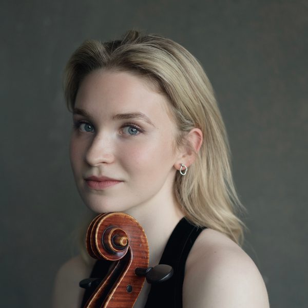Sophie Kauer poses for camera with a cello.